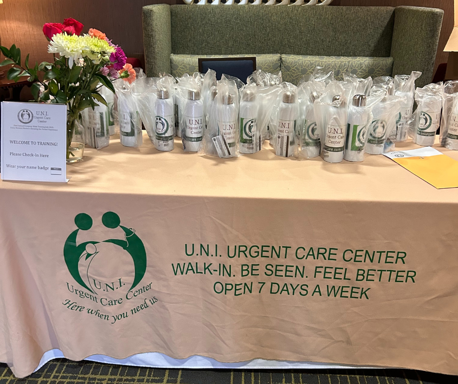 UNI Urgent Care Training Day welcome table with branded gift bags and sign-in station.